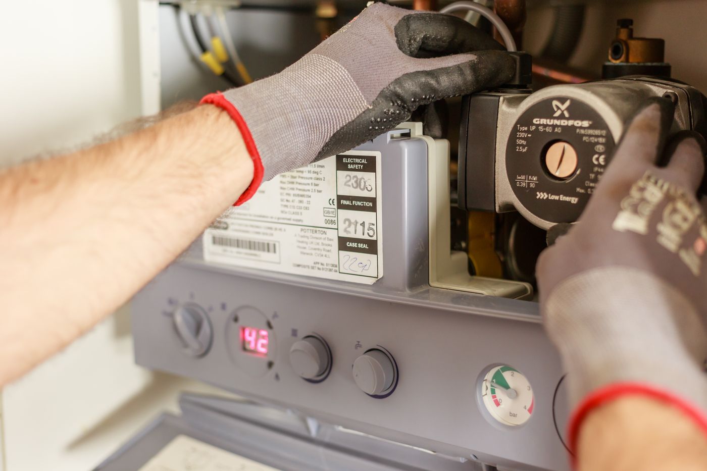 A Gas Safe engineer servicing a UK combi boiler